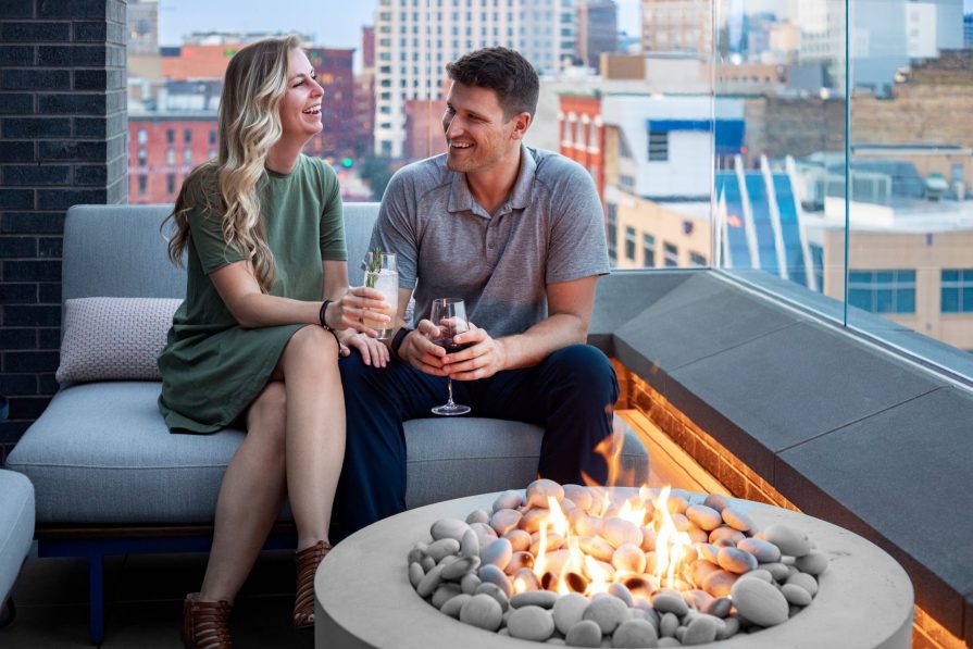 Couple with drinks at a fire pit